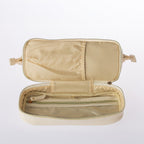 Fully opened cream cosmetic organiser bag featuring internal zip pocket and organised storage sections on a white background.