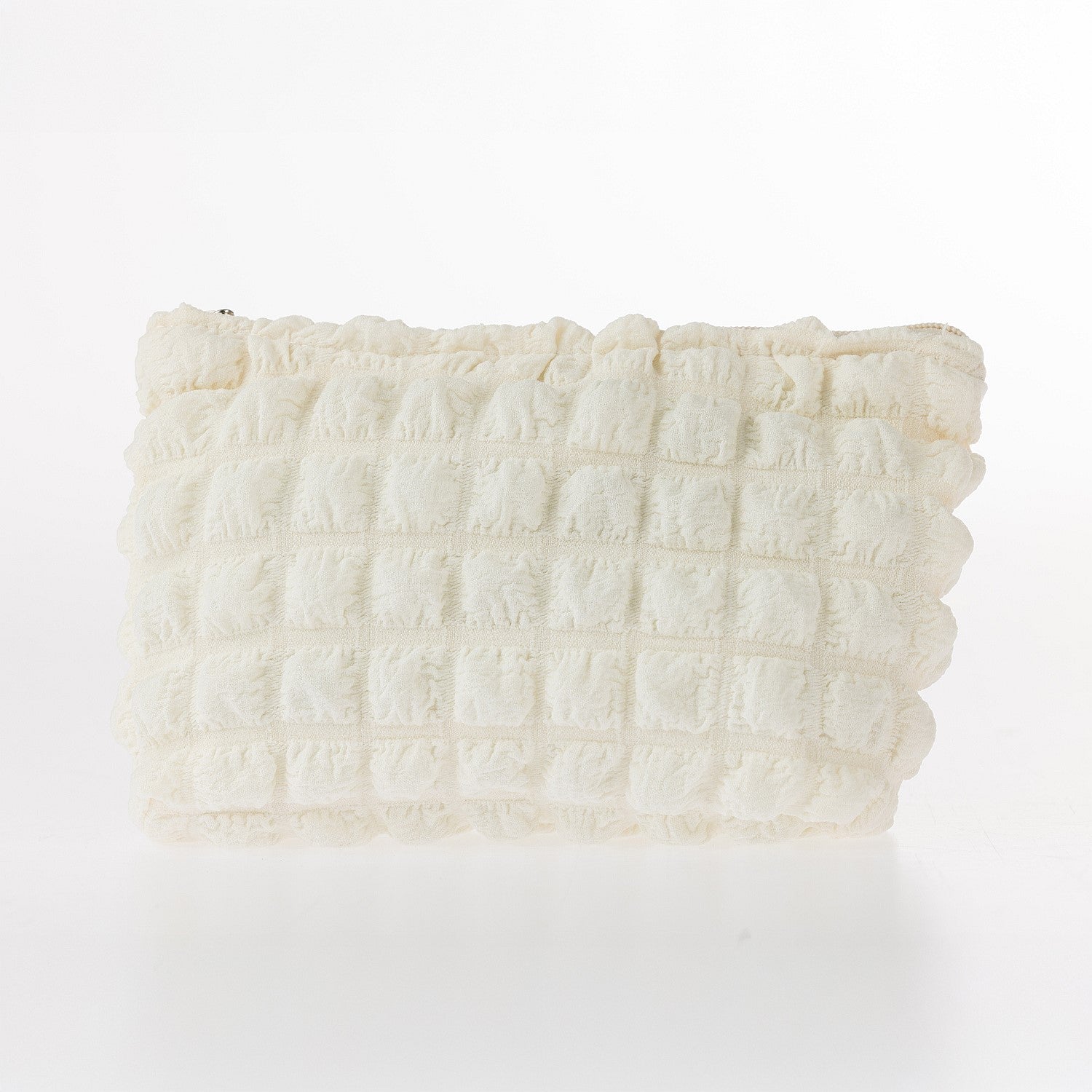 Cream textured waffle cosmetic pouch with soft padded finish and zip closure on a white background.