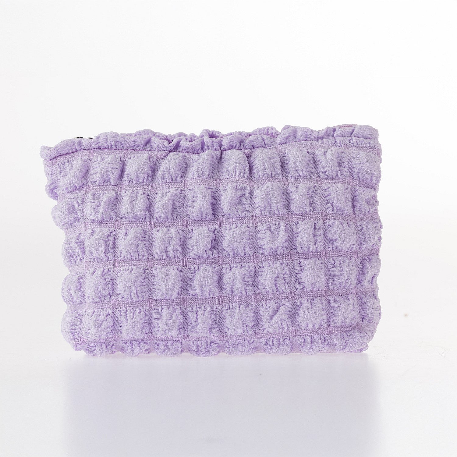 Lilac textured waffle cosmetic pouch with soft padded finish and zip closure on a white background.