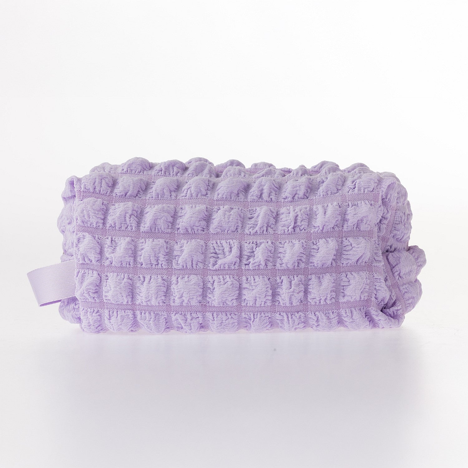 Lilac textured waffle toiletry bag with zip closure on a white background.
