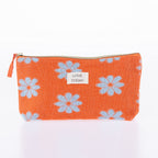 Orange floral cosmetic pouch with soft textured fabric, zip closure, and “Love Today” label on a white background.