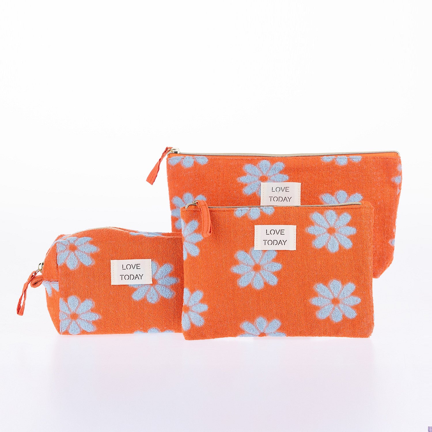 Coordinating orange floral cosmetic pouch set with zip closures and “Love Today” labels displayed on a white background.