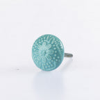 Sea Foam ceramic round drawer knob with embossed floral pattern detailing and metal screw fitting.