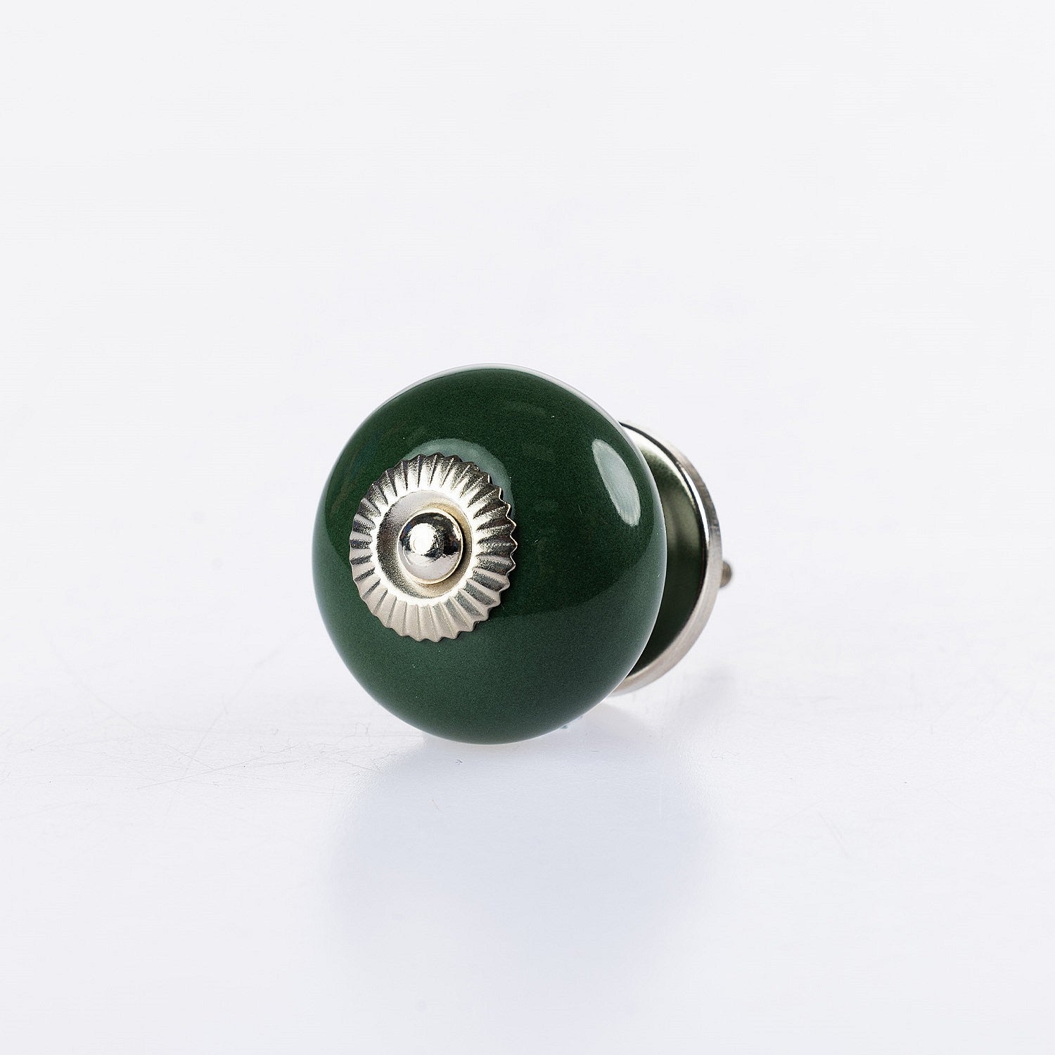 Dark green round ceramic drawer knob with silver metal centre accent and glossy finish.
