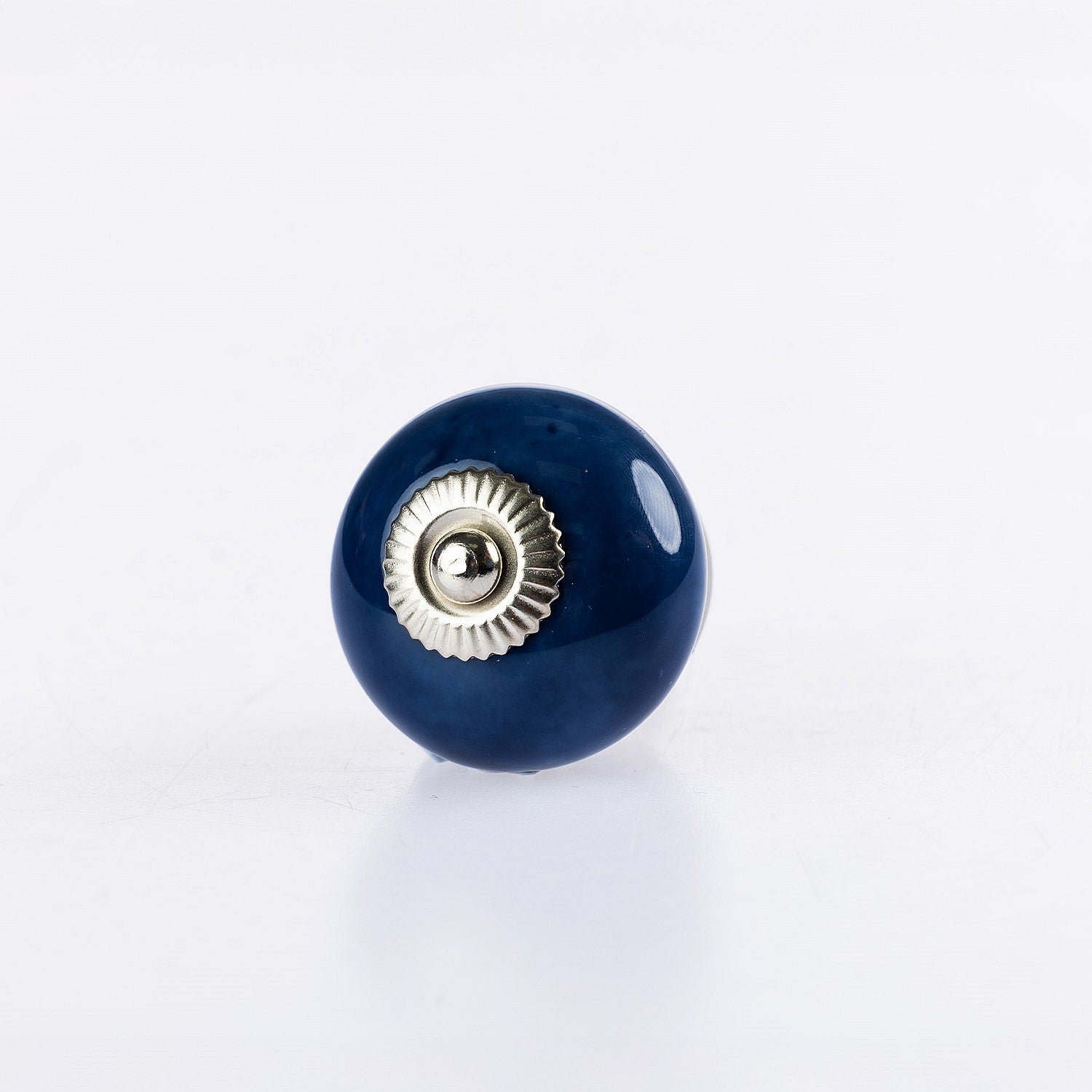 Navy blue round ceramic drawer knob with silver metal centre accent and glossy finish.
