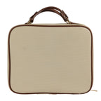 Neutral canvas vanity case with brown trim and structured carry handle on a white background.
