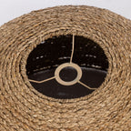 Close-up of a woven lampshade with a black interior and visible wiring.