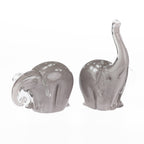 Pair of smoke grey hand-blown glass elephant figurines with white spotted detailing, shown from different angles against a white background.