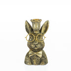 Decorative rabbit candleholder with gold glasses, bow tie, and crown on a white background.