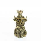 Decorative Highland Cow candleholder with gold glasses, bow tie, and crown on a white background.