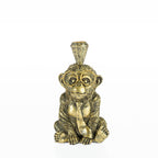 Decorative monkey candleholder with gold glasses, tie, and crown on a white background.