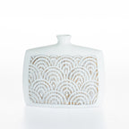 Cove Malaya Décor Urn Small in Brown/White, featuring a wide ceramic silhouette with a textured carved arch pattern and a distressed white finish.