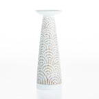 Cove Malaya Candle Holder in Brown/White, featuring a tall tapered candle holder with a textured carved arch pattern and a distressed white finish.