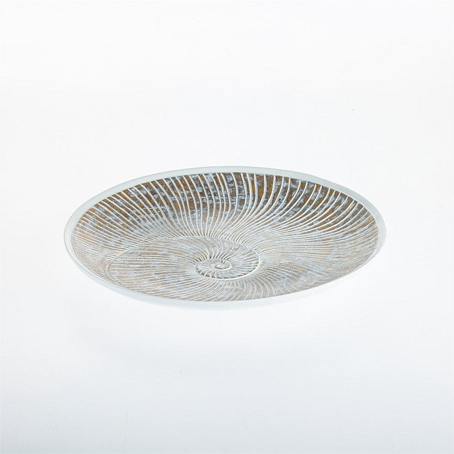 A shallow round glass plate with a textured, sunburst pattern of fine lines in warm brown and white, photographed from directly above on a seamless white background.