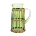 Design Republique Millie tall green glass pitcher with a curved handle, pouring spout and natural woven rattan-style wrap.