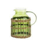 Design Republique Millie large green glass jug with a curved handle, pouring spout and woven rattan-style wrap around the base.