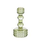 Light green glass candle holder with raised bubble detailing and a sculpted stem on a white background.