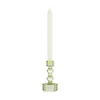 Light green glass candle holder with raised bubble detailing, holding a tall cream taper candle on a white background.