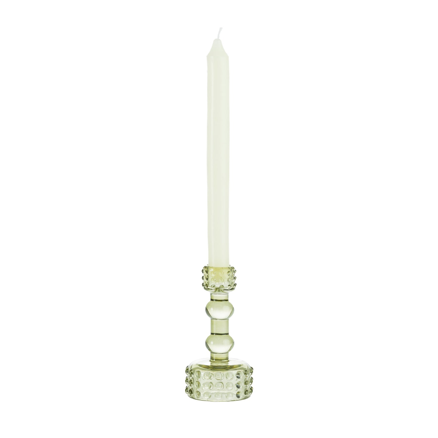 Light green glass candle holder with raised bubble detailing, holding a tall cream taper candle on a white background.