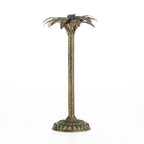 Gold palm tree candle holder with a tall textured stem, round decorative base, and leaf-shaped top on a white background.
