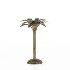 Gold palm tree candle holder with a tall textured stem, round decorative base, and leaf-shaped top on a white background.