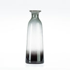 Smoke grey glass bottle vase on a white background.