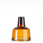 Amber glass vase with a short neck on a white background.