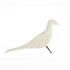 White decorative bird ornament side view with black metal legs on a white background.