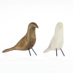 Gold and white decorative bird ornaments with black metal legs on a white background.