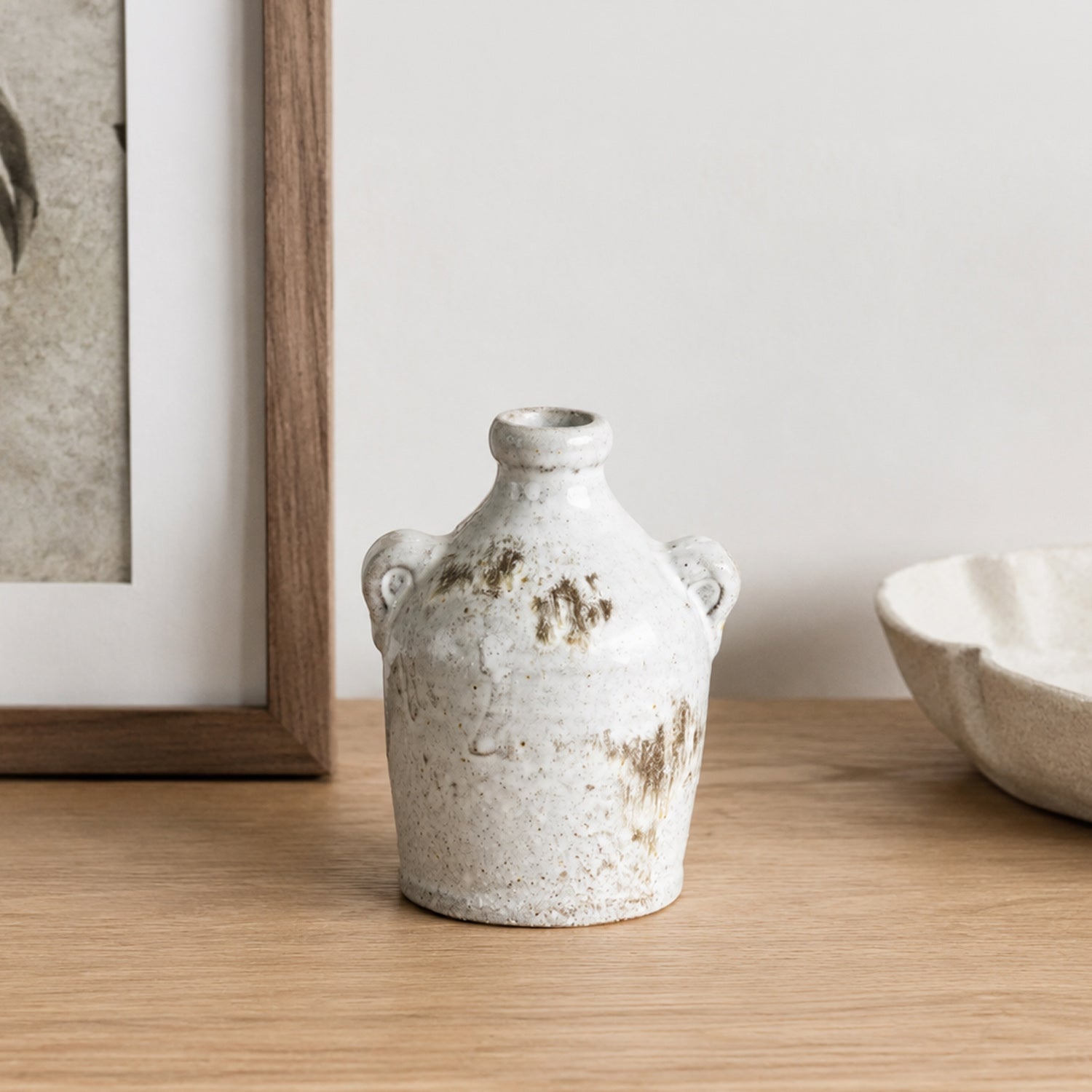 Small Cove Franco Ceramic Ears Vase styled on a wooden console beside a framed print and decorative bowl.