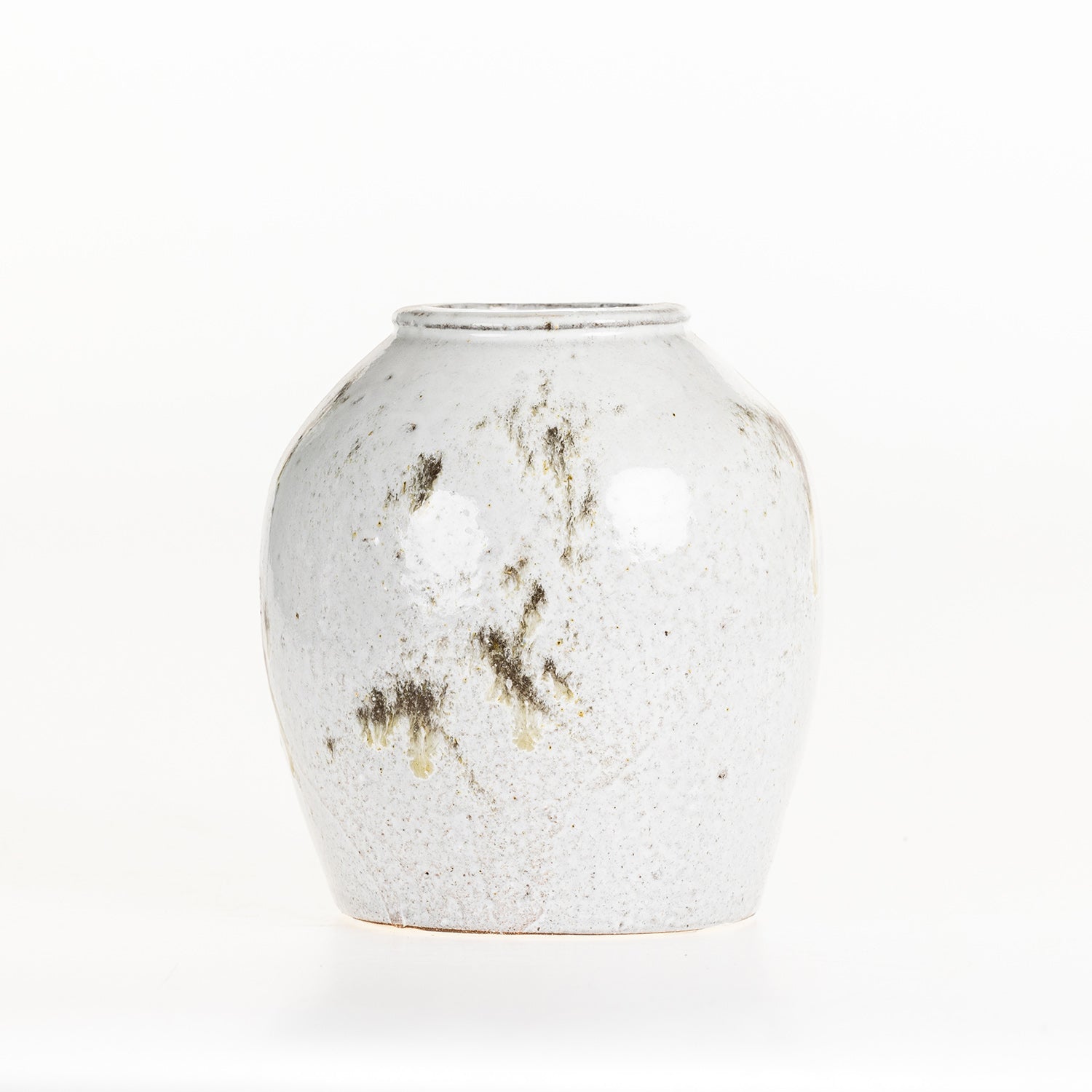 Small round ceramic vase with a reactive glaze finish on a white background.