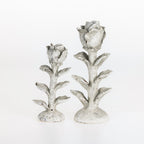 Small and large flower-shaped candle holders displayed side by side on a white background.