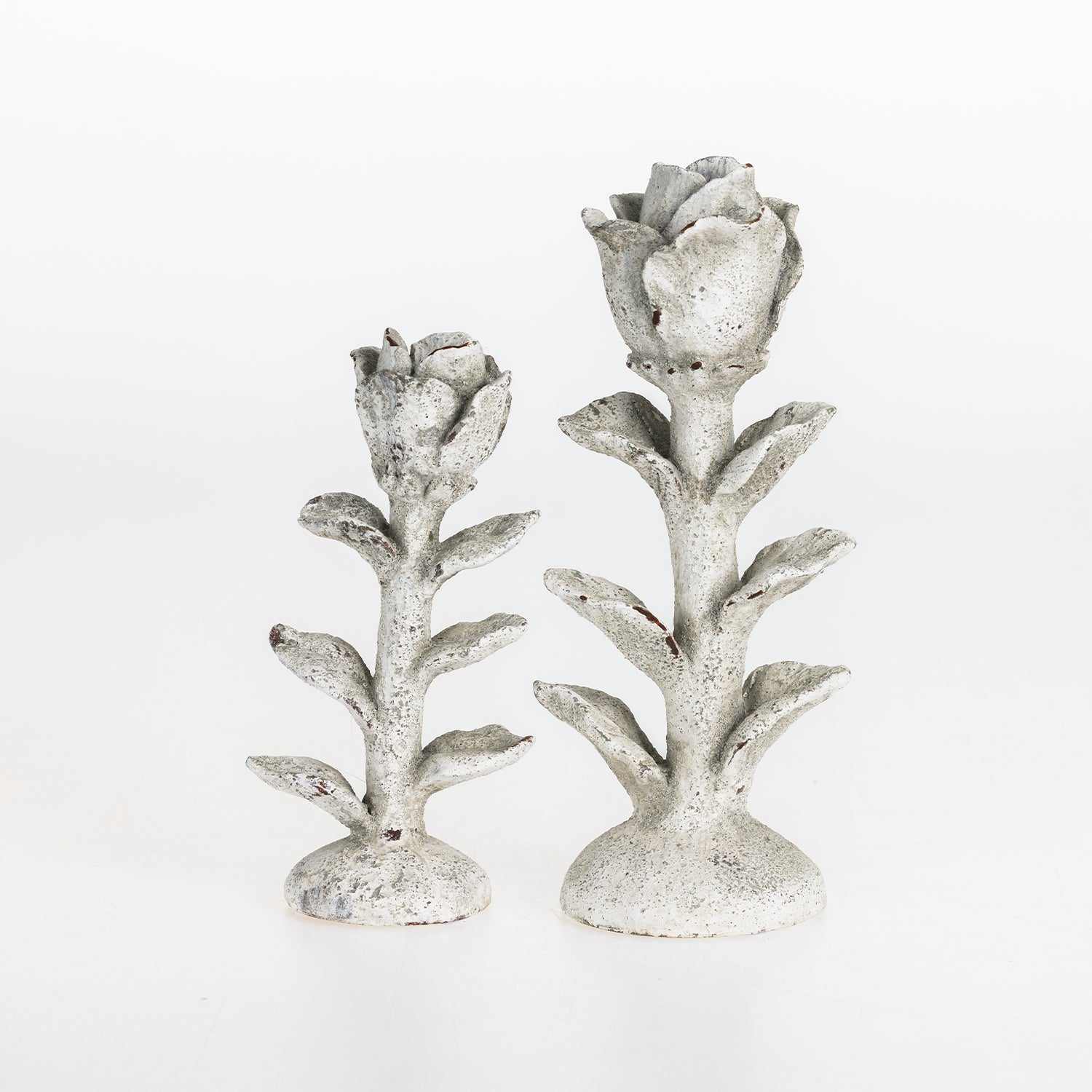 Small and large flower-shaped candle holders displayed side by side on a white background.