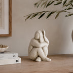 Cove Franco ceramic lady figurine displayed on a wooden console with olive branches and neutral décor in a warm, contemporary interior.