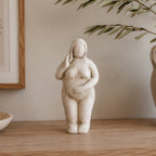 Cove Franco ceramic lady figurine displayed on a wooden console with olive branches and neutral décor in a warm, contemporary interior.