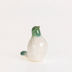 Glossy green and white ceramic bird figurine with an upright pose displayed on a white background.