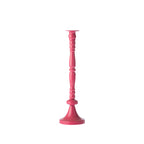 Fuchsia decorative candle holder with a glossy finish, tall turned column design and flared round base, shown against a white background.