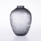 A textured glass vase with a hammered or honeycomb-like pattern, shown on a clean white background.