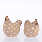 Two decorative wooden rooster figurines with white polka dots and brown combs, shown on a clean white background.
