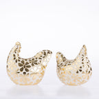 Two decorative chicken figurines in a glossy white finish with metallic gold floral cutout patterns, shown on a seamless white background.
