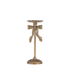 An antique bronze candlestick holder with a decorative bow detail on the stem, set against a plain white background.