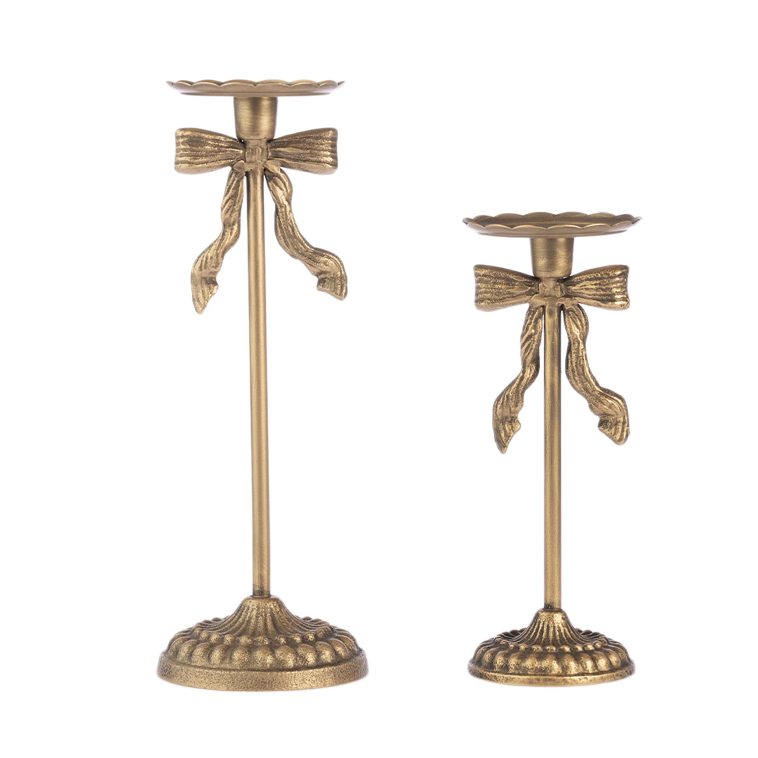 Two antique bronze candlesticks with decorative ribbon-bow details and scalloped flower-shaped candle holders, shown on a plain white background.
