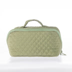 Light green quilted toiletry bag with a zip-around closure and top carry handle on a white background.