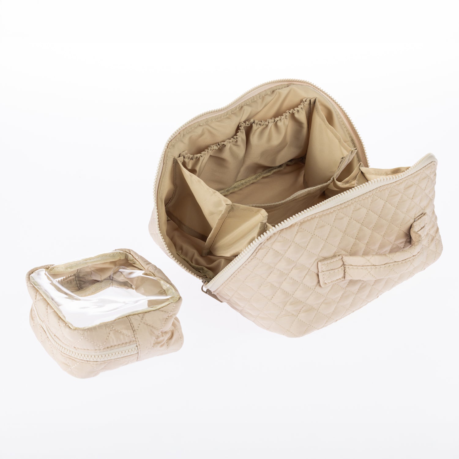 Open tan quilted toiletry bag showing internal compartments and a matching removable clear pouch.