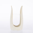Ivory textured candle holder with a curved sculptural frame and clear glass insert.