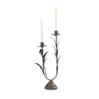 Antique bronze metal two-candle holder with decorative leaf detailing and two white taper candles.