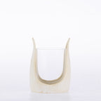 Ivory textured candle holder with a curved sculptural frame and clear glass insert.