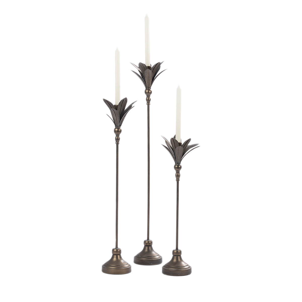 Set of three antique bronze metal candle holders in varying heights with white taper candles and decorative leaf-shaped tops.