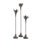 Set of three antique bronze metal candle holders in varying heights with decorative leaf-shaped tops and round bases.
