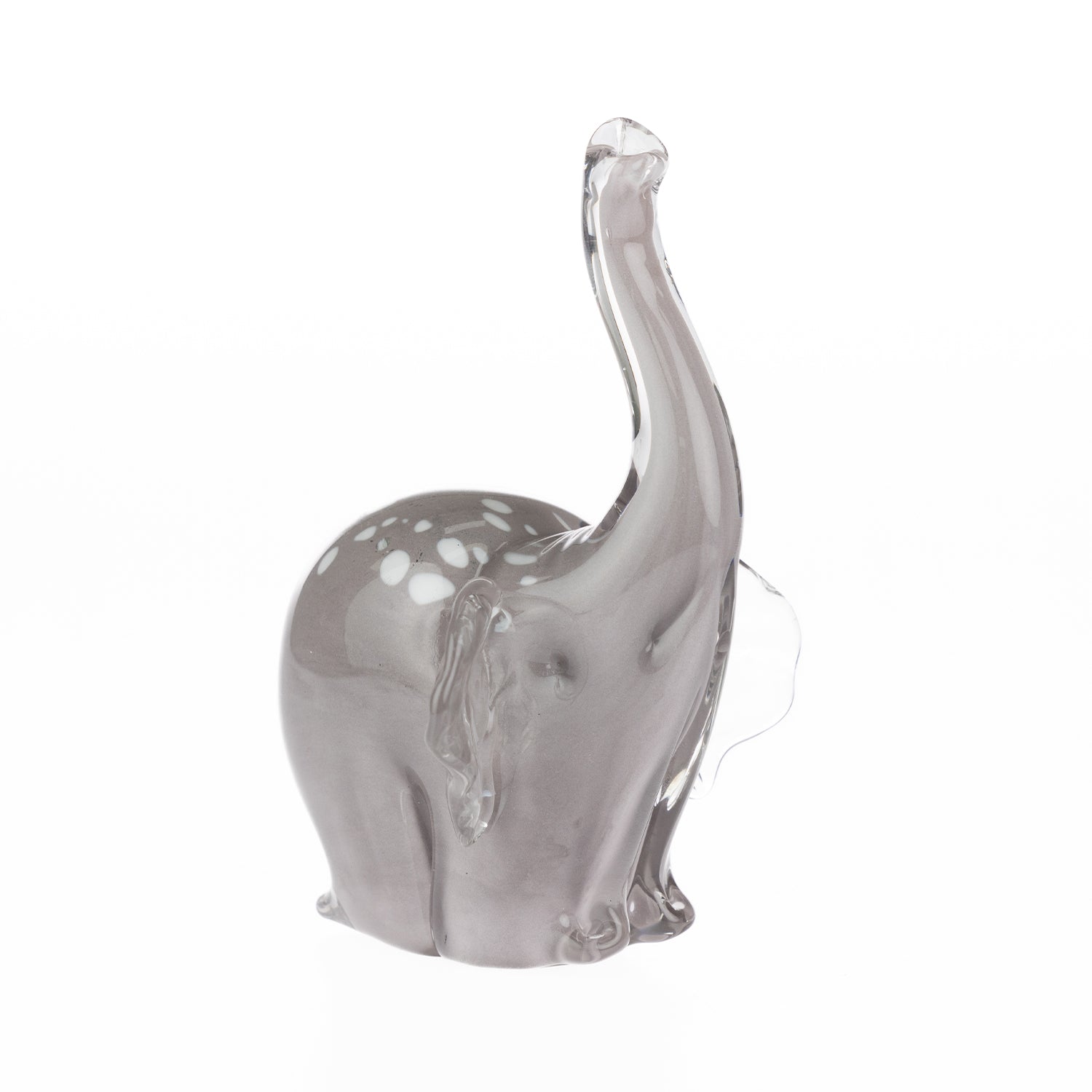 Smoke grey hand-blown glass elephant figurine with a raised clear glass trunk, white spotted detailing, and translucent glass ears, displayed against a white background.